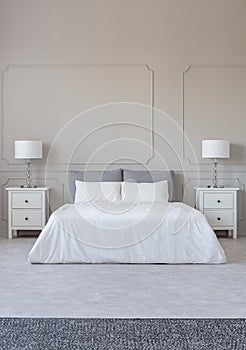 New york style bedroom interior with symmetric design, copy space on empty grey wall