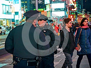 NEW YORK TIMES SQUARE, APR,24, 2015: Most beautiful New York Times Square police officer woman among tourists and people. NYC NYPD
