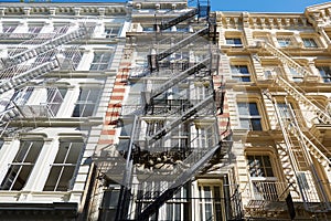 New York typical building facades with fire escape stairs