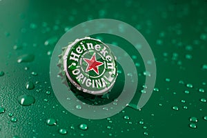 New York, UNITED STATES OF AMERICA - February 20, 2020: classic cap close-up of Heineken on a green background with drops of water