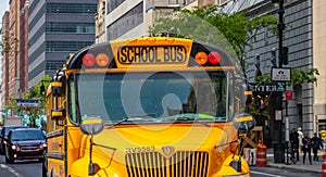 Yellow classic public school bus on the street, New York, Manhattan downtown