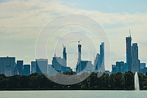 NEW YORK, USA - August 30, 2018: Pond in the central park in NYC. Central Park and Manhattan Skyline. Midtown Manhattan skyline