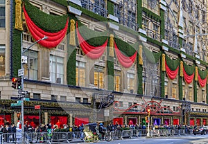 Christmas decorations red ribbons, wreaths and lights on the flagship Saks Fifth Avenue store in Manhattan New York, USA