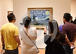 New York, USA - June 8, 2018: People near the Starry Night by Vi