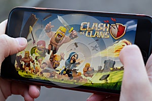 New York, USA - 1 May 2020: Clash of Clans game mobile app logo close-up on phone screen, Illustrative Editorial