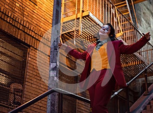 NEW YORK, USA,-NOVEMBER 31,2019: Random person impersonating the Joker and dancing at staircase in the Bronx, New York