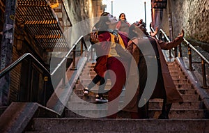 NEW YORK, USA,-NOVEMBER 31,2019: The tourist attraction staircase in Bronx, with a man impersonating the joker and a random woman