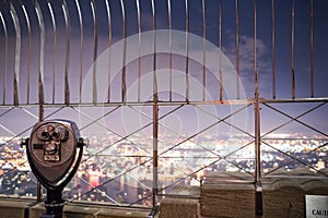 Binoculars on top of Empire State Building at Night in Manhattan photo