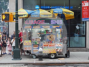 New York, USA. Street food. Fast food cart selling hot dogs and other snack or food in New York City. Food trucks along the town