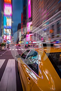 New york yellow cab under bright lights of Times Square