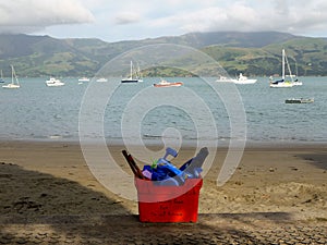 New Zealand: Akaroa harbour beach with community equipment