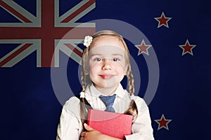 New Zealand concept with child girl student with book against the New Zealand flag background