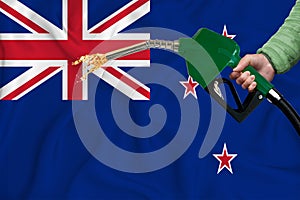 NEW ZEALAND flag Close-up shot on waving background texture with Fuel pump nozzle in hand. The concept of design solutions. 3d