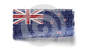 New Zealand flag on a piece of cloth on a white background