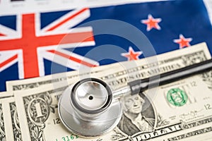 New Zealand flag with US dollar banknotes money on graph, Business and finance concept