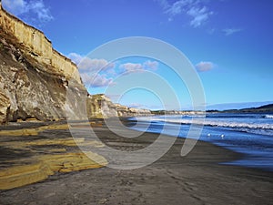 New Zealand Gemstone beach with high sandstone cliff