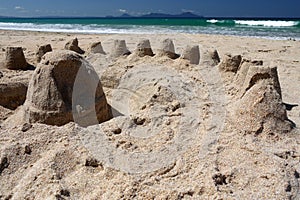 New Zealand: summer beach sand castles h photo