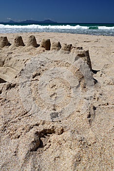 New Zealand: summer beach sand castles photo