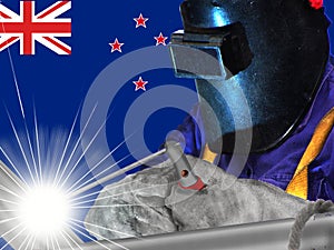NEW ZEALANDER WELDER WITH BACKGROUND OF HIS FLAG