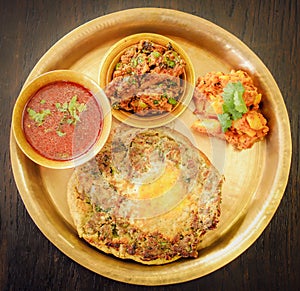 Newar food in a tray isolated on a wooden surface - great for an article about traditional foods photo