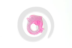 Newbor pink toy. A colorful baby rattle on a white horizontal background
