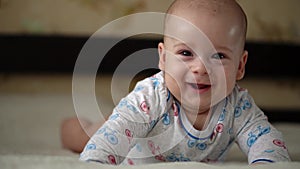 Newborn Active Baby Cute Smiling Teethless Face Portrait Early Days On Stomach Developing Neck Control. 5 Months Child