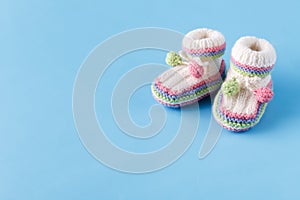 Newborn announcement Baby booties on blue with copy space