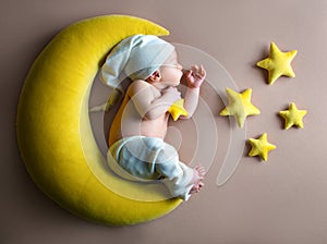Newborn babies in costums, baby boy on the moon photo