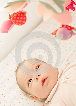 Newborn baby admiring toys