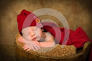 Newborn baby in antique bucket