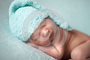 Newborn baby asian boy sleeping at blue background