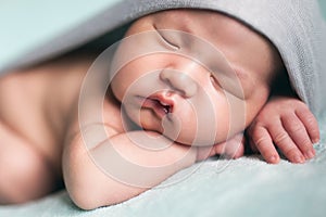 Newborn baby asian boy sleeping at blue background