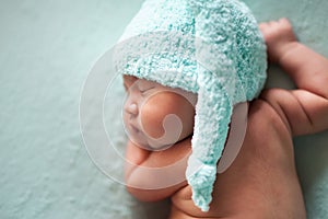 Newborn baby asian boy sleeping at blue background