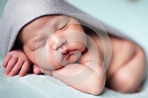 Newborn baby asian boy sleeping at blue background