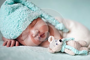 Newborn baby asian boy sleeping at blue background