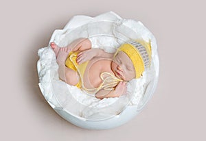 Newborn baby asleeps in basket