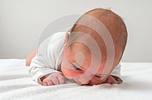 Newborn baby beginning to pick up his head on his own