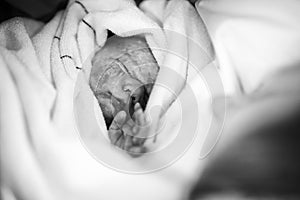 Newborn baby being born via Caesarean Section. Mother looking for the first time on new born daughter. Newborn child