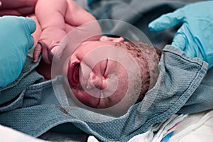 Newborn baby being cleaned up