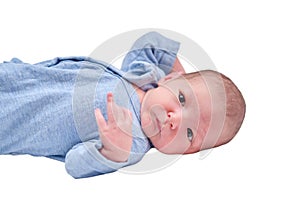 A newborn baby in blue clothes on a changing table, isolated on a whit