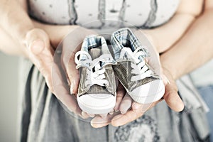 Newborn baby booties in parents hands