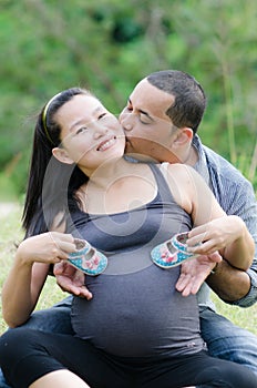 Newborn baby booties in parents hands,