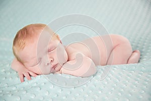 Newborn baby boy against green background