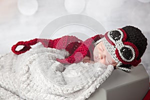 Newborn baby boy with airplane outfit