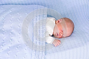 Newborn baby boy on a blue blanket