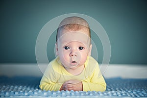 Newborn baby boy on blue carpet closeup