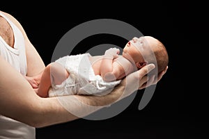 Newborn baby boy on the father's hand