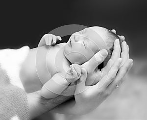 Newborn baby boy on the father`s and mother`s hand.