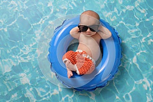 Newborn Baby Boy Floating on an Inflatable Swim Ring