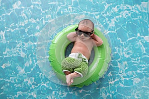 Newborn Baby Boy Floating on a Swim Ring